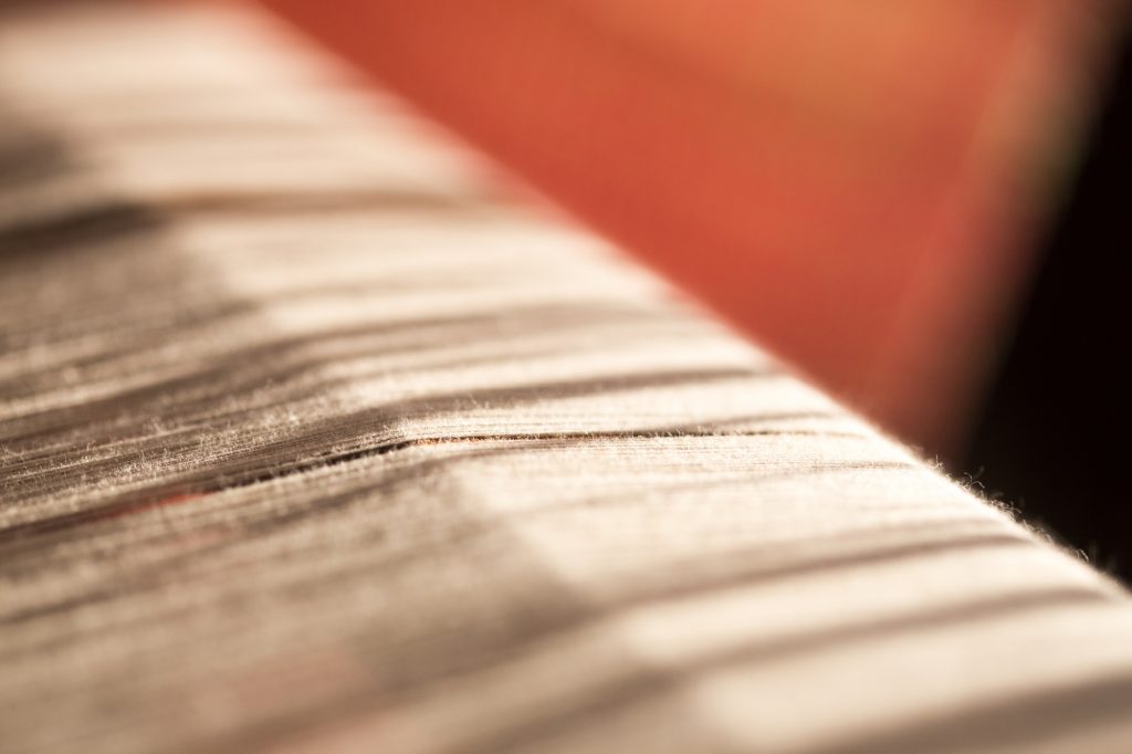 white silk thread in sewing or weaving machine,texture,background,selected focus