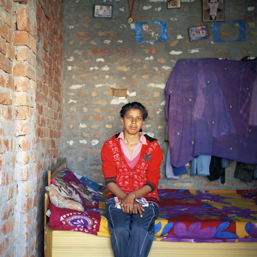 Ritu, 19, sits in her home in Bhapur, Haryana, India. Ritu is the highest educated Dalit girl in her village, currently in the second year of her BA. "My father is not interested in me studying, but my mother has supported me to go to school. Whatever anyone has said, she has not listened. That''s why she is going out and working for us at a factory." Ritu''s mother makes the equivalent of $94 USD per month working at a sewing factory and is the sole earner of the household.